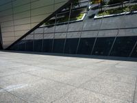 the view of the exterior of a modern looking building in daylight time with reflection of its windows