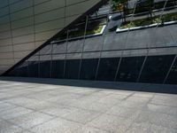 the view of the exterior of a modern looking building in daylight time with reflection of its windows