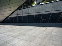 the view of the exterior of a modern looking building in daylight time with reflection of its windows