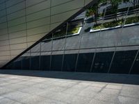 the view of the exterior of a modern looking building in daylight time with reflection of its windows