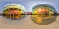 a wide angle view of a modern building made of glass and metal the facade is brightly colored