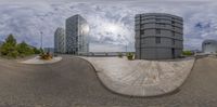 two buildings are seen in this fish - eye lens picture with a man standing on the sidewalk