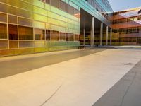 two large windows on a modern building with orange and yellow paint on the windows and outside