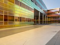 two large windows on a modern building with orange and yellow paint on the windows and outside