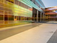 two large windows on a modern building with orange and yellow paint on the windows and outside