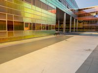 two large windows on a modern building with orange and yellow paint on the windows and outside