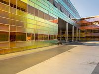 two large windows on a modern building with orange and yellow paint on the windows and outside