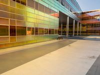 two large windows on a modern building with orange and yellow paint on the windows and outside