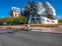 modern building in the desert with concrete and aluminum in front of it on a blue sky day