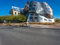 modern building in the desert with concrete and aluminum in front of it on a blue sky day