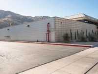 a view of a building in the middle of an empty parking lot with no signs on it