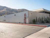 a view of a building in the middle of an empty parking lot with no signs on it