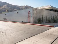 a view of a building in the middle of an empty parking lot with no signs on it