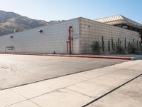 a view of a building in the middle of an empty parking lot with no signs on it