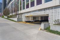 there is a building that has a very large parking space on one side and a street with no cars