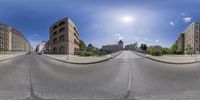 a fish eye lens looking down an empty street, at a building on the left side