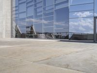 a modern looking building with some big glass windows on the side of the building is blue and has a brown roof