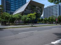 modern looking buildings near street next to sidewalk and trees on pavement and street side in city