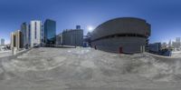 the view of an empty parking lot on a city street with tall buildings in the background