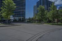 a street lined with lots of trees and tall buildings in the background - image by the eye of a person