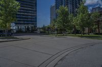 a street lined with lots of trees and tall buildings in the background - image by the eye of a person