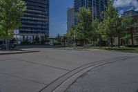 a street lined with lots of trees and tall buildings in the background - image by the eye of a person