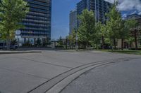 a street lined with lots of trees and tall buildings in the background - image by the eye of a person