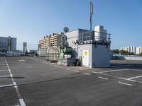 a large commercial air conditioner sitting in a parking lot next to some tall buildings