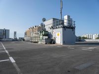 a large commercial air conditioner sitting in a parking lot next to some tall buildings