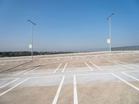 a empty parking lot with the light posts on each side of the empty street area