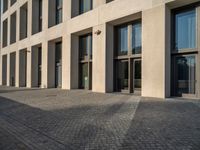 an empty sidewalk near buildings in a city area of europe, in front of blue sky