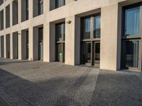 an empty sidewalk near buildings in a city area of europe, in front of blue sky