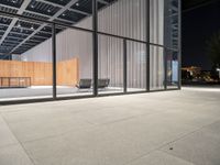 a room with a fence and windows at night on a city street, with modern design