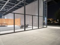 a room with a fence and windows at night on a city street, with modern design