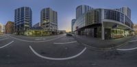 360 view of the street corner in a city at night with a sky background and traffic