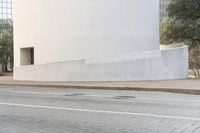 a person is riding a skateboard down the street in a city with buildings in the background