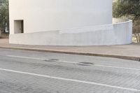 a person is riding a skateboard down the street in a city with buildings in the background