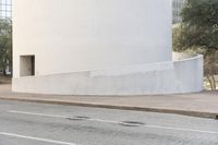 a person is riding a skateboard down the street in a city with buildings in the background