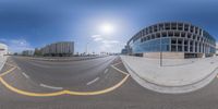 360 - view of the road with buildings in the background, a large round building with a curved front