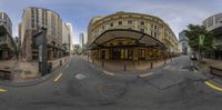 there are buildings on the side of this street reflecting in a fish eye lens,