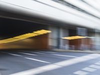 a blurry image of a man on his motorcycle approaching the subway entrance while he walks