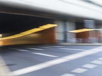 a blurry image of a man on his motorcycle approaching the subway entrance while he walks