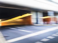 a blurry image of a man on his motorcycle approaching the subway entrance while he walks