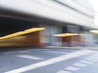 a blurry image of a man on his motorcycle approaching the subway entrance while he walks