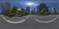 the sun shines on an empty, empty city street from its angle as cars pass by