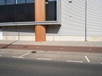 a view of a car park on the street and buildings near by and a man in a red jacket