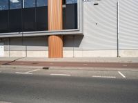 a view of a car park on the street and buildings near by and a man in a red jacket