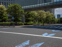 empty road with white lines on the streets of city area against cloudy blue sky on a sunny day