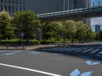 empty road with white lines on the streets of city area against cloudy blue sky on a sunny day