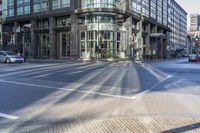 this is an image of an intersection at city streets and buildings along side the road